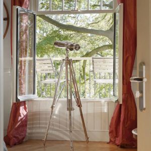 Super-Seat | Zwei weiße Metallstühle auf dem Balkon, Blick auf grüne Bäume, roter Vorhang. | Catering Möbel